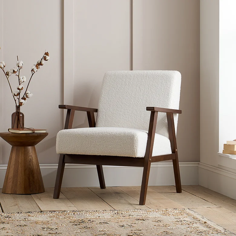 boucle accent chair in walnut frame with earthy tones and neutral textured styling