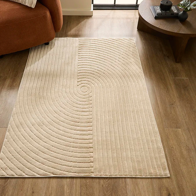Neutral cream office rug with sculpted 3D carved arcs and linear pattern (Sydney 3D Effect Rug in Natural), styled in a modern home office / living space to add subtle texture, definition and a design-led focal point under a desk or reading chair.