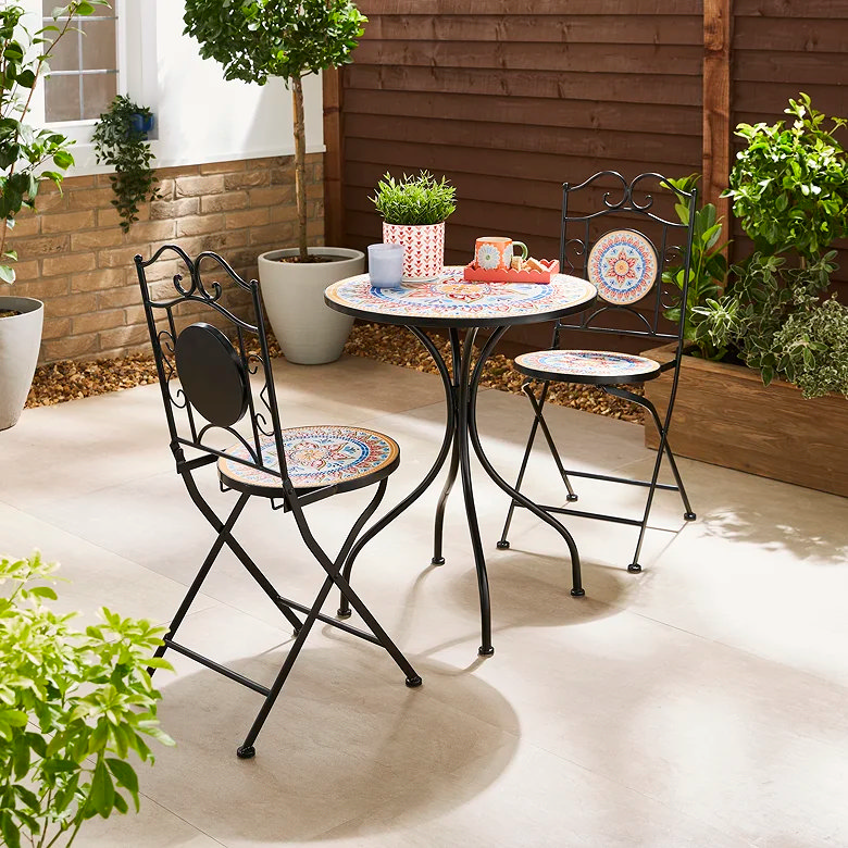 Luxury mosaic bistro set with patterned table and folding chairs creating a colourful garden seating corner