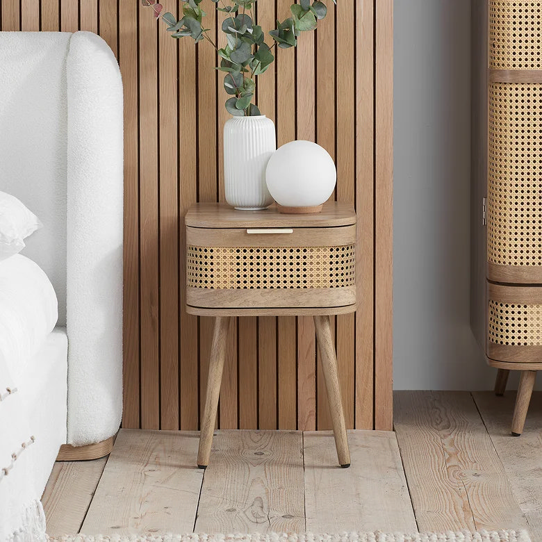 bedroom with oak bedside table featuring rattan drawer and slatted wood wall