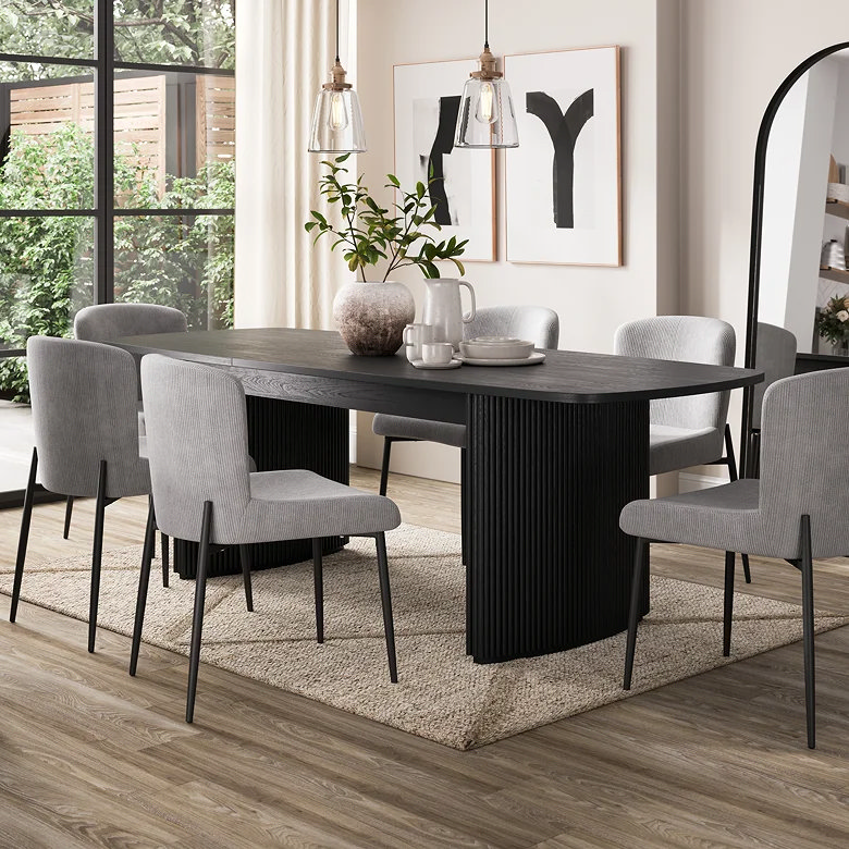 Black dining table styling with greenery vase and simple decor