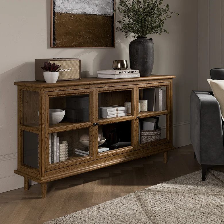 Smoked oak sideboard with glass doors and books.