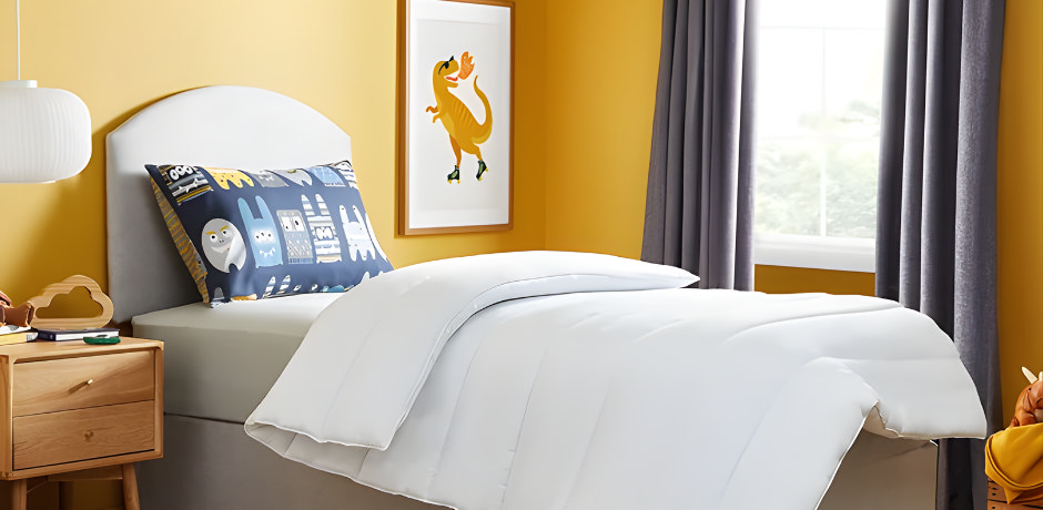 Butter yellow kids’ bedroom with white bedding and playful wall art.