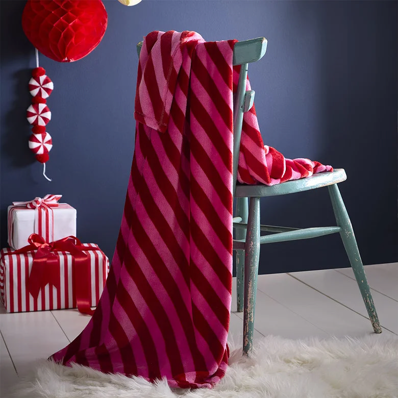 pink candy stripe christmas throw over chair