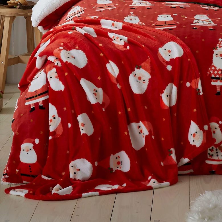 red christmas couch throw with santa illustrations
