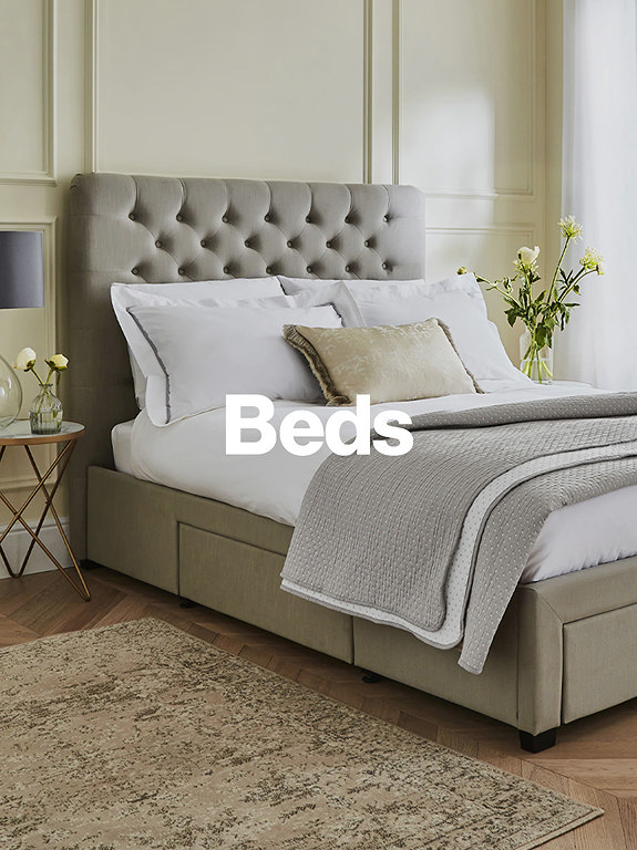 Grey MFI bed with pillows and throws