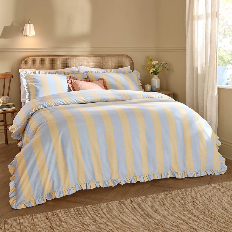 blue and yellow striped couples bedding with ruffles