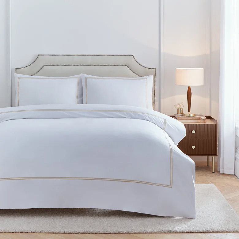 neutral white bedding for couples with embroidered trim