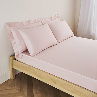 mattress on a bed covered with pale pink fitted sheet in 30cm depth, with matching pillowcases