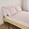 mattress on a bed covered with pale pink fitted sheet in 30cm depth, with matching pillowcases