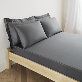 mattress on a bed covered with charcoal grey fitted sheet in 30cm depth, with matching pillowcases
