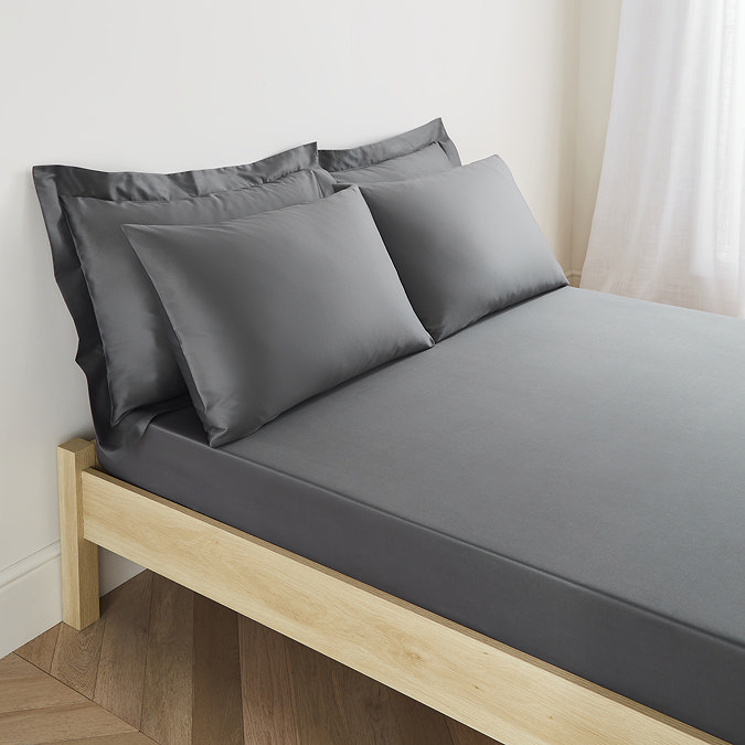 mattress on a bed covered with charcoal grey fitted sheet in 30cm depth, with matching pillowcases