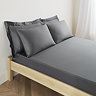 mattress on a bed covered with charcoal grey fitted sheet in 30cm depth, with matching pillowcases