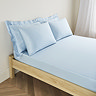mattress on a bed covered with light blue fitted sheet in 30cm depth, with matching pillowcases