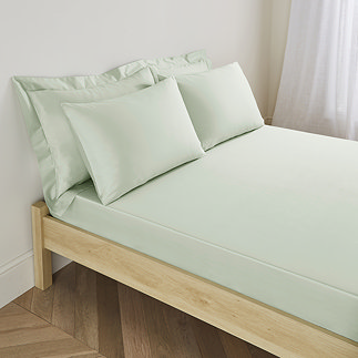 Deep fitted sheet in sage on bed image 1