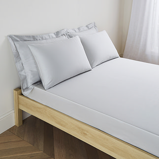 mattress on a bed covered with silver fitted sheet in 30cm depth, with matching pillowcases