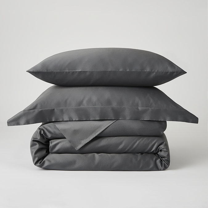 image of charcoal grey duvet cover folded up with matching oxford and standard pillows stacked on top