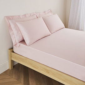 mattress on a bed covered with pale pink fitted sheet in 30cm depth, with matching pillowcases