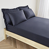 mattress on a bed covered with dark blue fitted sheet in 40cm depth, with matching pillowcases