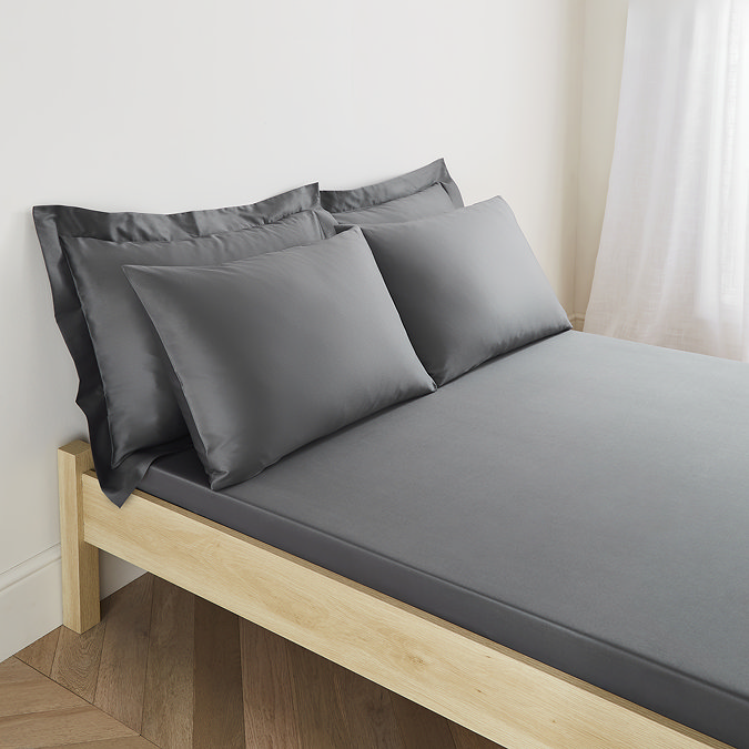 image of bed with charcoal grey fitted sheet and matching pillowcases