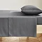 charcoal grey flat sheet pressed neatly on a bed with matching pillowcase