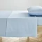 light blue flat sheet pressed neatly on bed with matching pillow