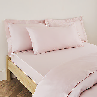 Kingsize Pillow in Blush on a bed image 1