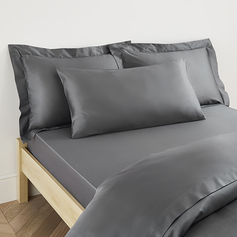 Kingsize Pillow in Charcoal on a bed image 1