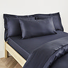 Kingsize Pillow in Dark Blue on a bed image 1