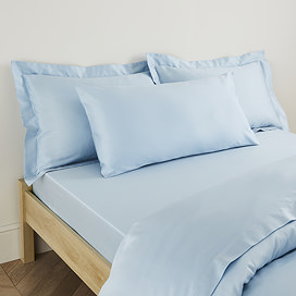 Kingsize Pillow in Light Blue on a bed image 1