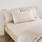 Kingsize Pillow in Natural on a bed image 1