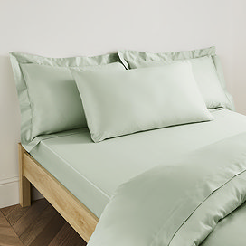 Plain Dye Kingsize Pillowcase in Sage on bed image 1