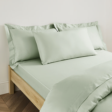 Plain Dye Kingsize Pillowcase in Sage on bed image 2