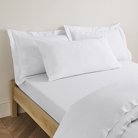 Kingsize pillowcase in white on bed image 1