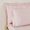 Oxford Pillowcase pair in Blush on a bed image 1