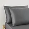 close up on pair of pillows in charcoal grey pillowcases at head of bed