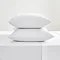 white cotton sateen pillowcase pair, stacked on on top of the other, on a flat sheet