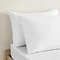 white cotton sateen pillowcase pair, one in front of the other, on a bed
