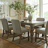 image of rectangular rustic dark brown dining table with upholstered chairs at every side