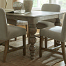 close up image on carved rounded legs of rustic dark brown dining table