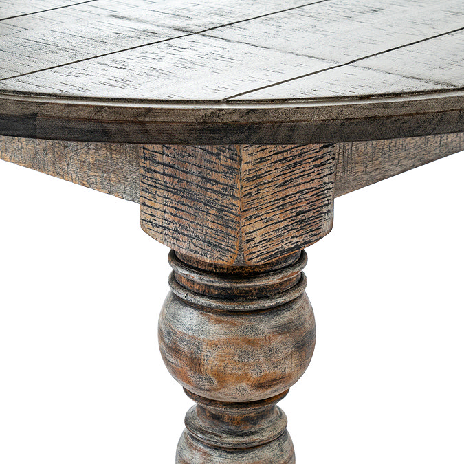 close up image of top of carved legs on dark wood round coffee table