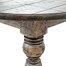 close up image of top of carved legs on dark wood round coffee table