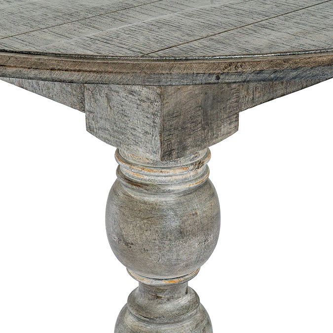 close up image of carved leg detail of dark brown round dining table
