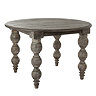 image cut out on white background of round dark brown rustic dining table with carved legs