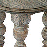 close up image of carve detail legs of dark oak rustic round side table