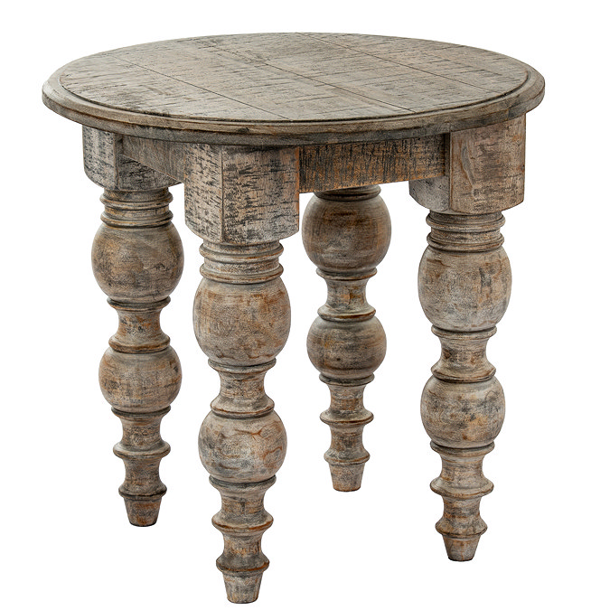 image cut out on white background of round rustic dark brown side table with carved legs