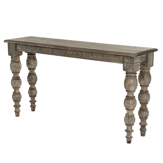 image cut out on white background of rectangular rustic dark brown console table with carved legs