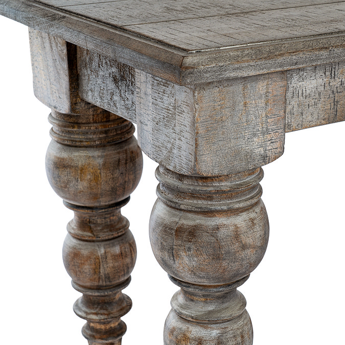 close up image of carved legs of dark wood dining bench