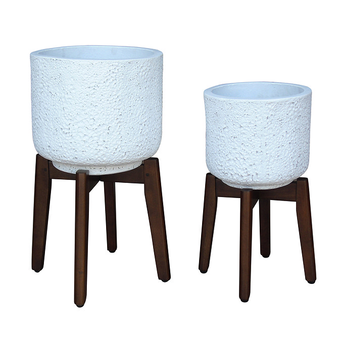 image cut out on white background of two white rounded mottled cement pots on acacia wood stands