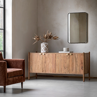 image of acacia wood sideboard with four doors and gold handles, against wall